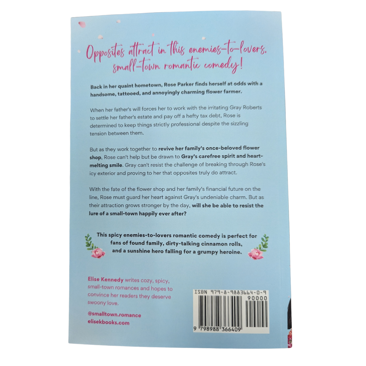 Accidentally in Bloom by Elise Kennedy paperback romance book featuring a couple kissing surrounded by pink flowers.