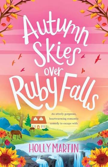 Autumn Skies over Ruby Falls by Holly Martin paperback cover featuring pink autumn skies, colorful fall leaves, a countryside cottage, horses, and a waterfall.