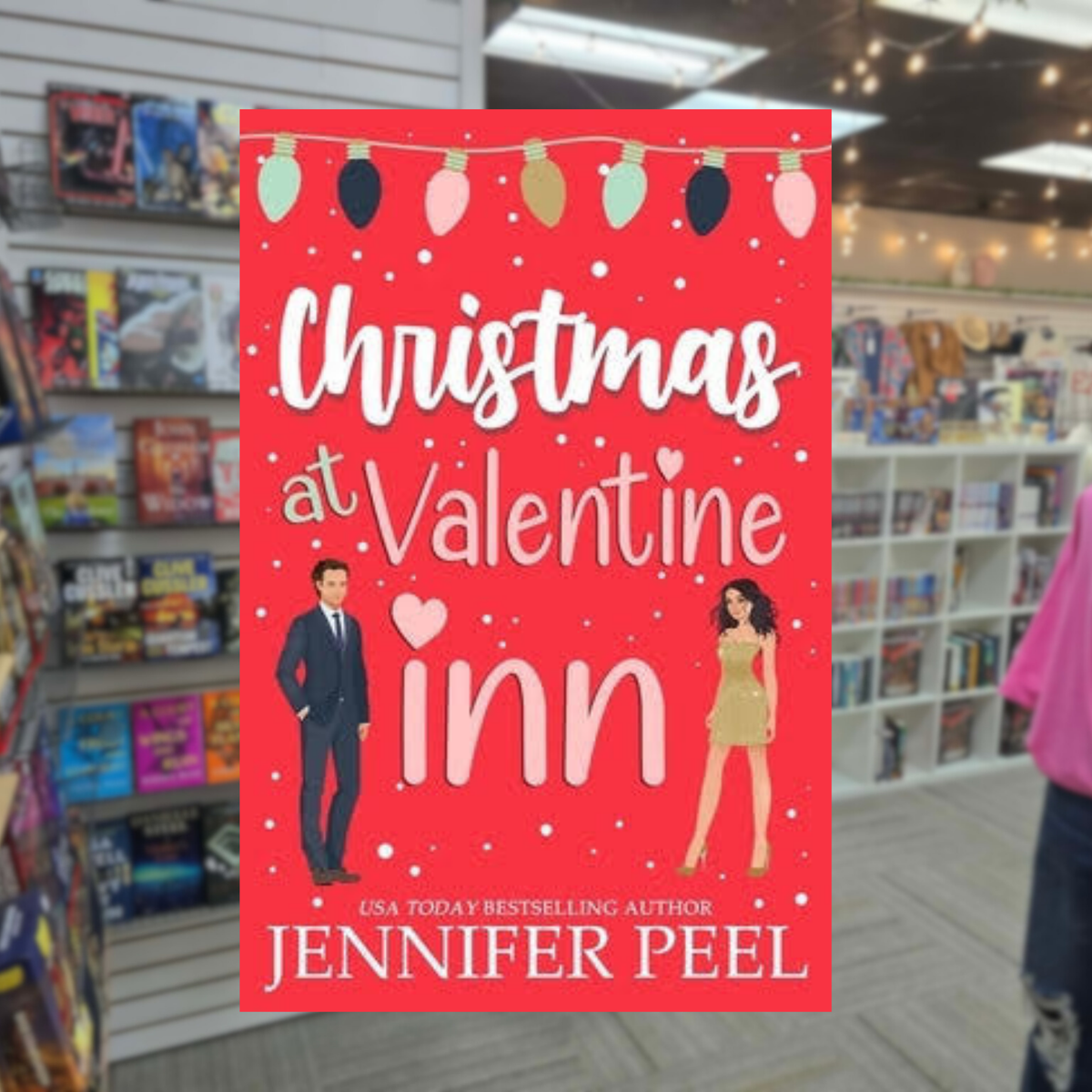 Christmas at Valentine Inn by Jennifer Peel romance book cover featuring a bright red background, Christmas lights, falling snow, and an illustrated man and woman.