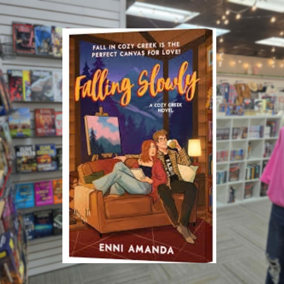 Falling Slowly by Enni Amanda paperback cozy autumn romance book cover featuring an illustrated couple relaxing together on a couch