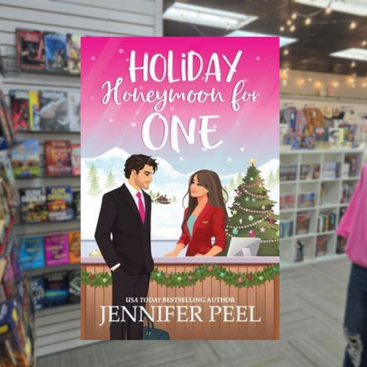 Holiday Honeymoon for One by Jennifer Peel Christmas romance book cover featuring an illustrated dark-haired man in a black suit and a brunette woman in red, with a decorated Christmas tree and snowy mountain scenery.