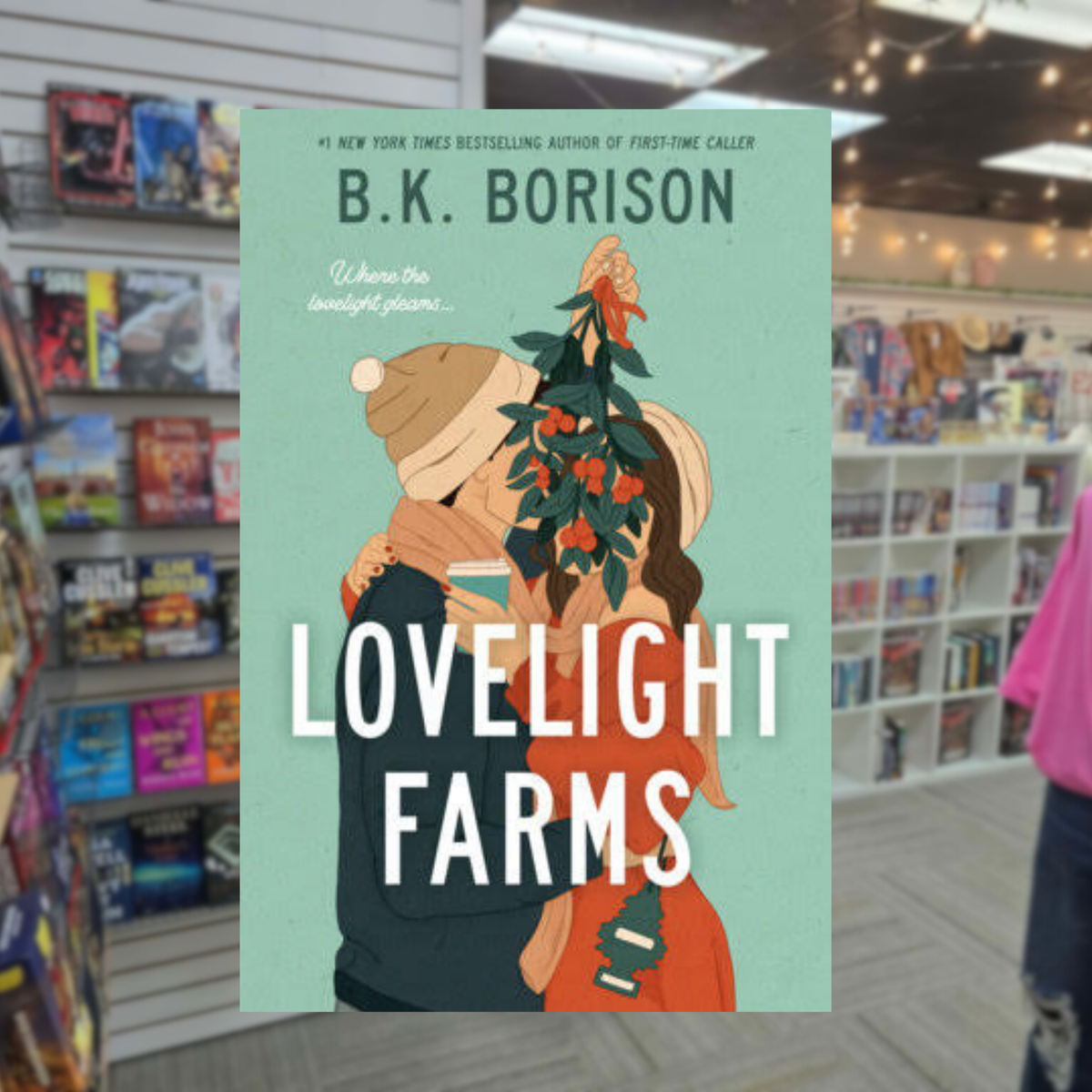 Lovelight Farms by B.K. Borison paperback Christmas romance book cover featuring an illustrated couple embracing beneath mistletoe
