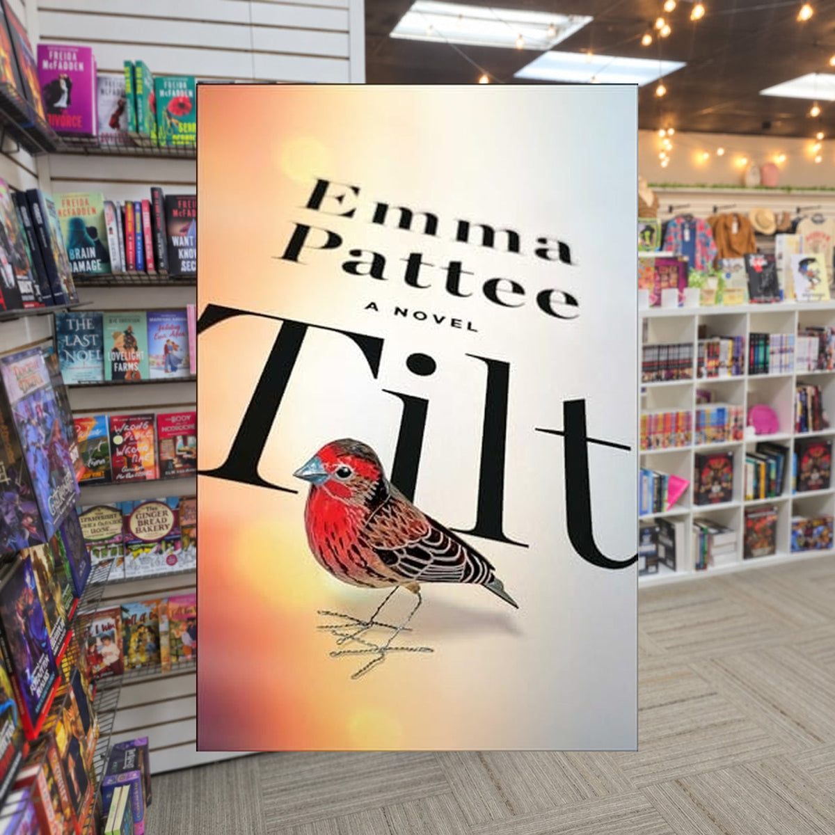 Tilt by Emma Pattee — actual cover on The Perk bookstore background