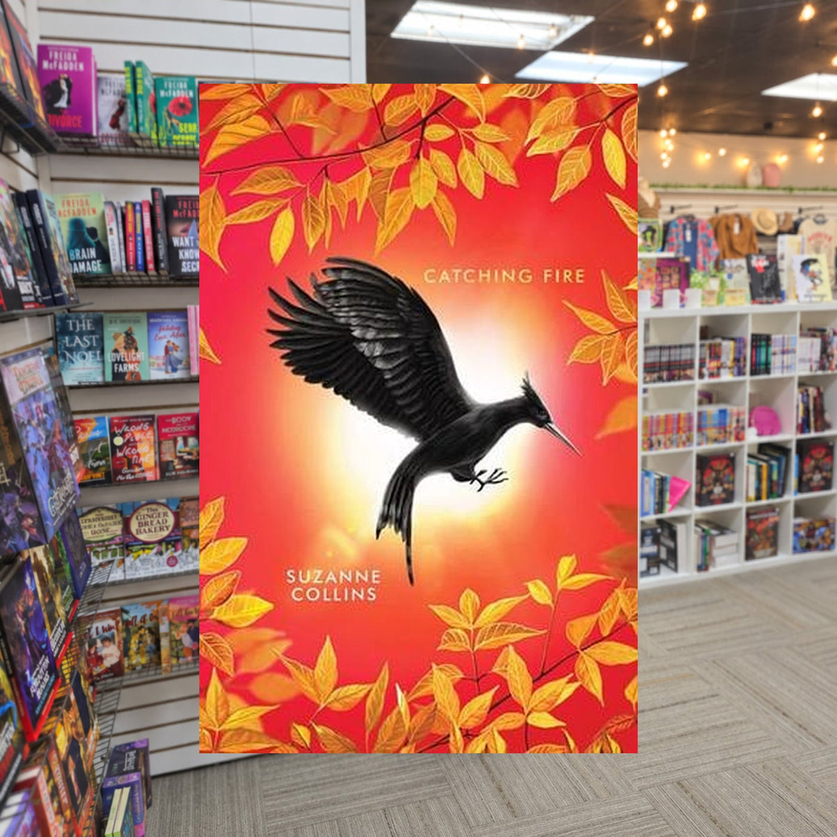 The Hunger Games #2 Catching Fire by Suzanne Collins — actual cover on The Perk bookstore background
