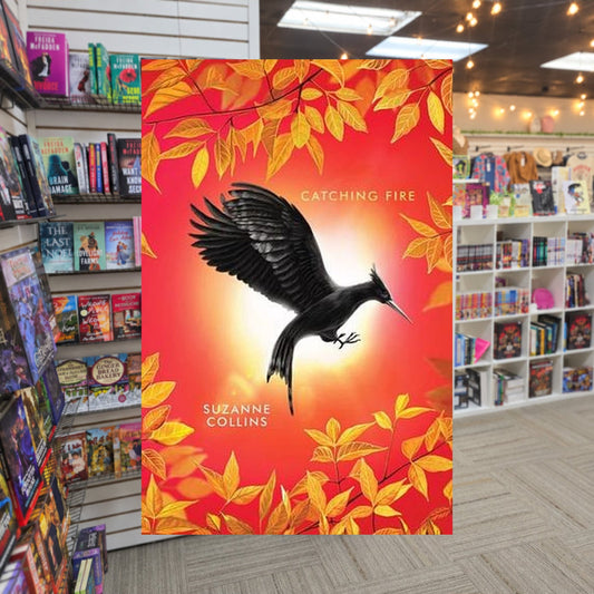 The Hunger Games #2 Catching Fire by Suzanne Collins — actual cover on The Perk bookstore background