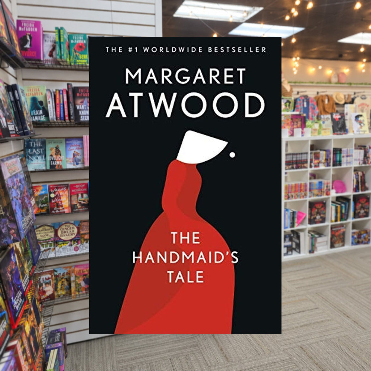 The Handmaid's Tale by Margaret Atwood — actual cover on The Perk bookstore background