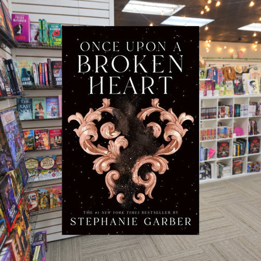 Once Upon a Broken Heart #1: Once Upon a Broken Heart by Stephanie Garber — actual cover on The Perk bookstore background