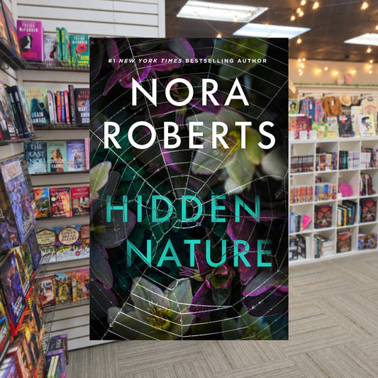 Hidden Nature by Nora Roberts — actual cover on The Perk bookstore background
