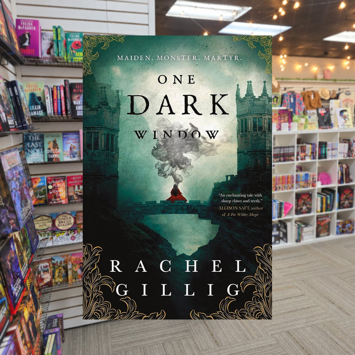 One Dark Window by Rachel Gillig — actual cover on The Perk bookstore background