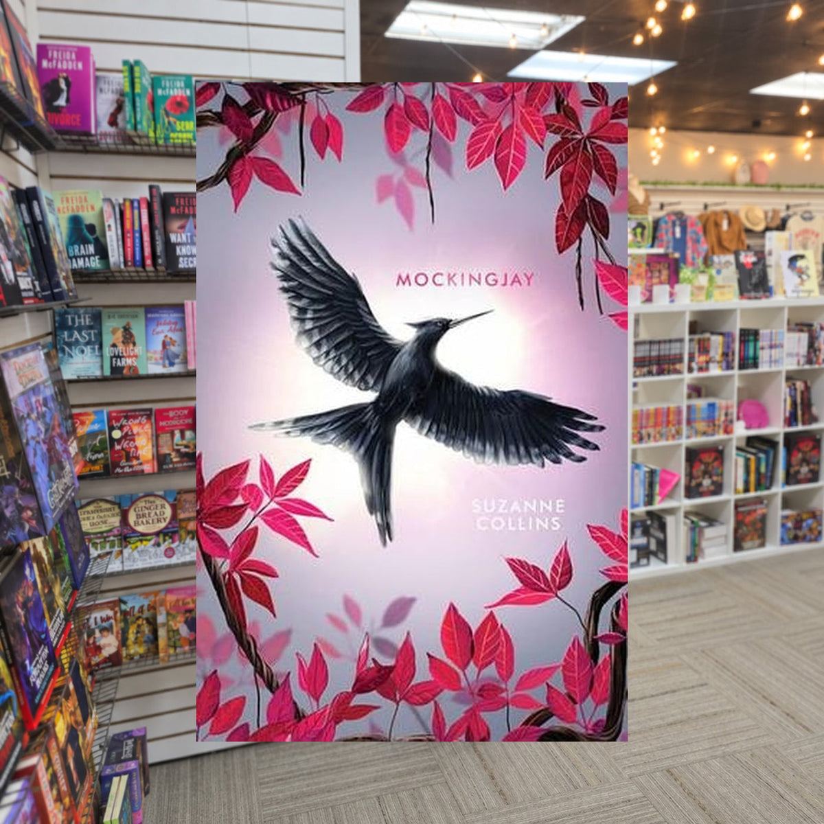 The Hunger Games #3: Mockingjay by Suzanne Collins — actual cover on The Perk bookstore background