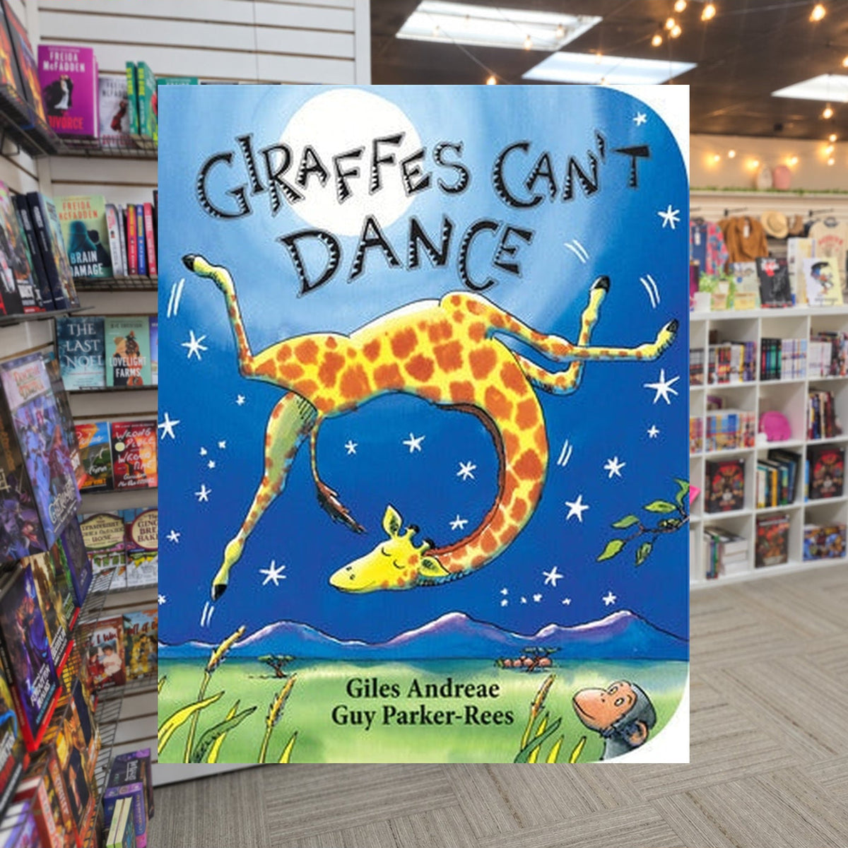Giraffes Can't Dance by Giles Andreae ,  Guy Parker-Rees — actual cover on The Perk bookstore background