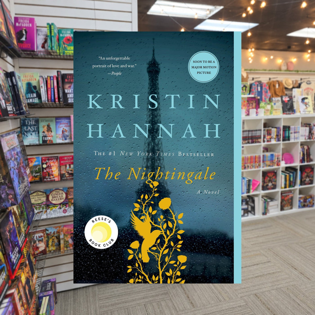 The Nightingale by Kristin Hannah — actual cover on The Perk bookstore background