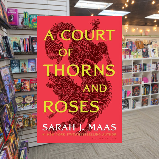 A Court Of Thorns and Roses by Sarah J. Maas — actual cover on The Perk bookstore background