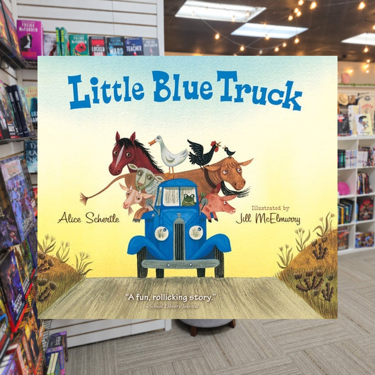 Little Blue Truck by Alice Schertle ,  Jill McElmurry — actual cover on The Perk bookstore background