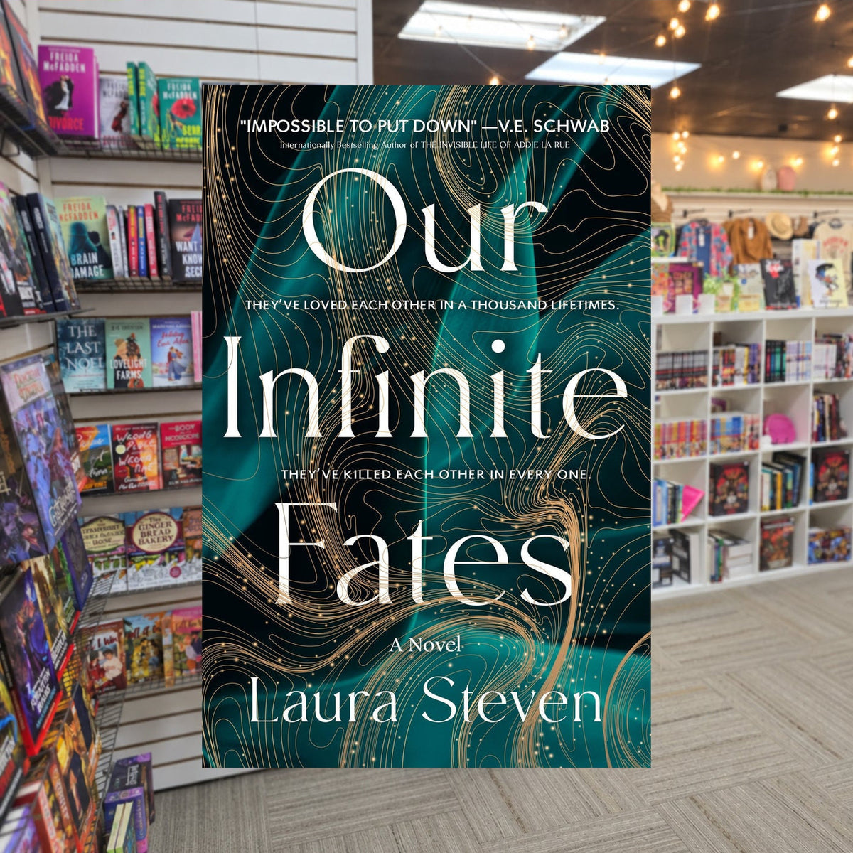 Our Infinite Fates by Laura Steven — actual cover on The Perk bookstore background