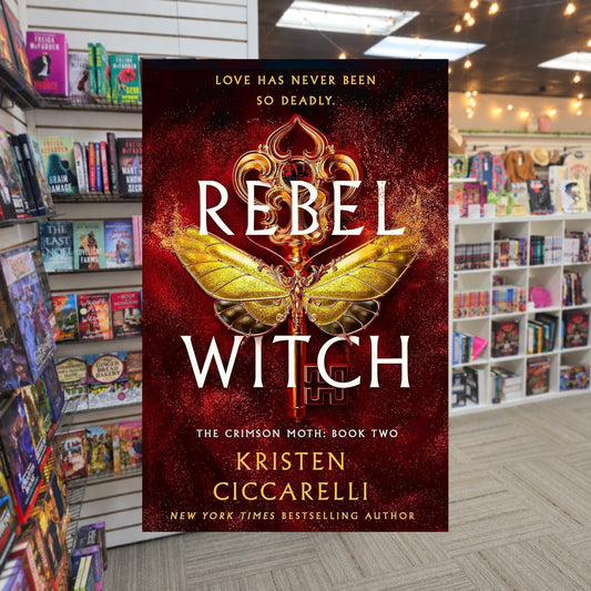 The Crimson Moth #2: Rebel Witch by Kristen Ciccarelli — actual cover on The Perk bookstore background