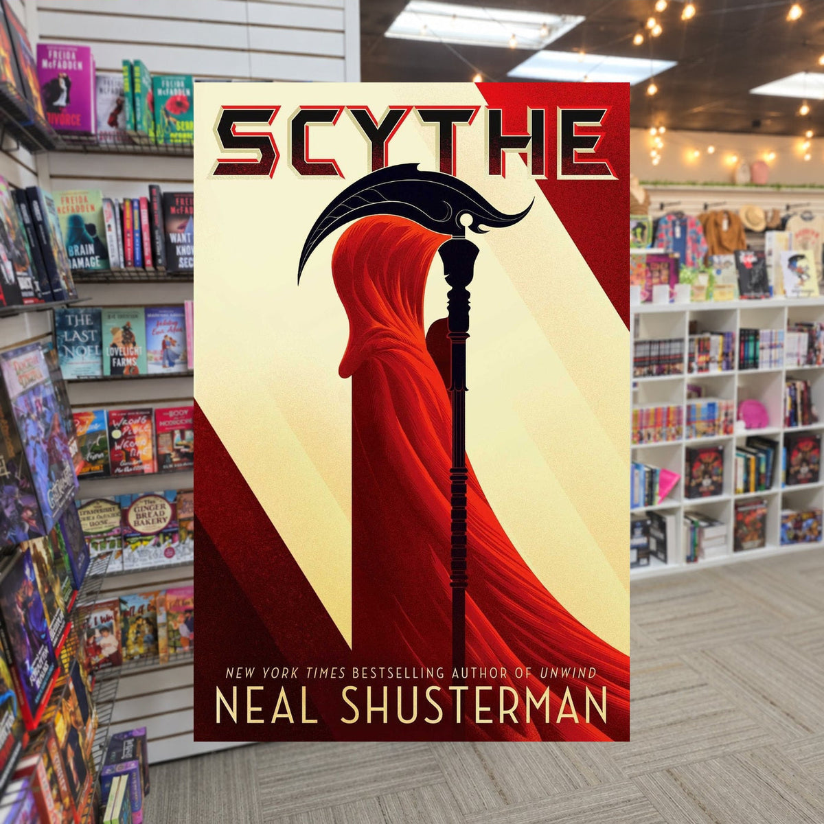Arc of a Scythe #1: Scythe by Neal Shusterman — actual cover on The Perk bookstore background