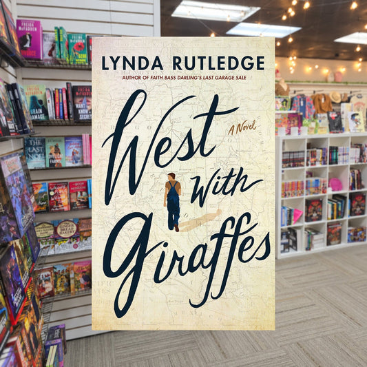 West With Giraffes by Lynda Rutledge — actual cover on The Perk bookstore background