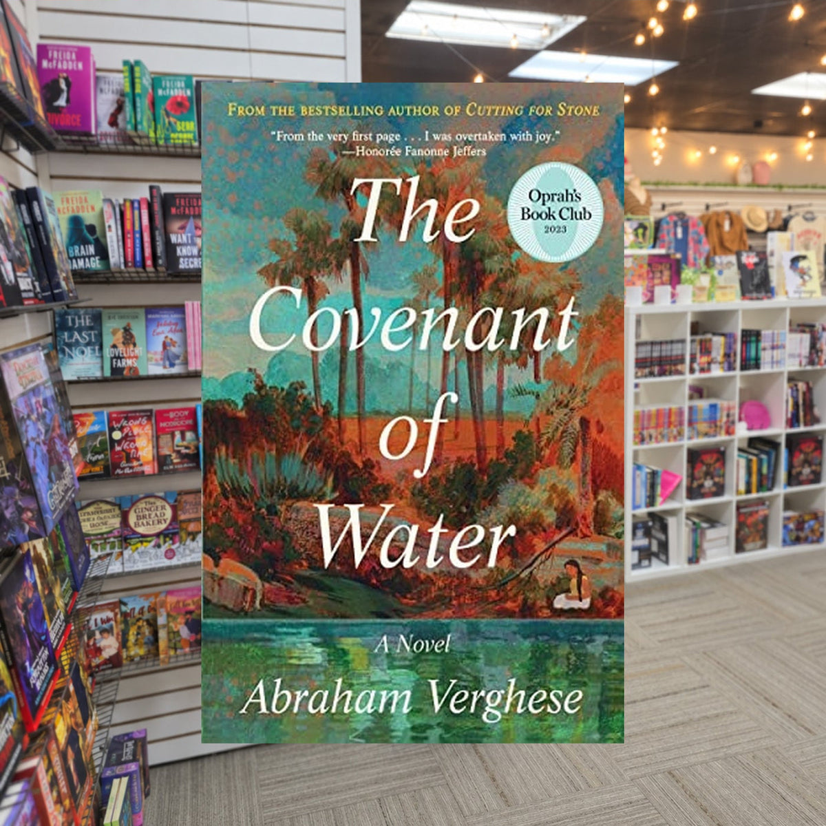 The Covenant of Water by Abraham Verghese — actual cover on The Perk bookstore background