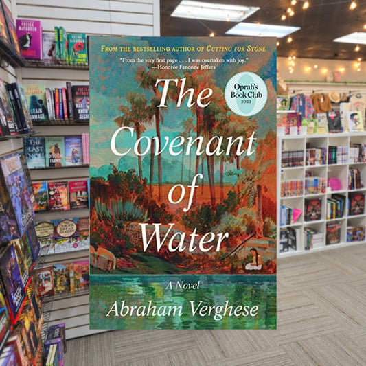 The Covenant of Water by Abraham Verghese — actual cover on The Perk bookstore background