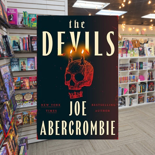 The Devils by Joe Abercrombie — actual cover on The Perk bookstore background