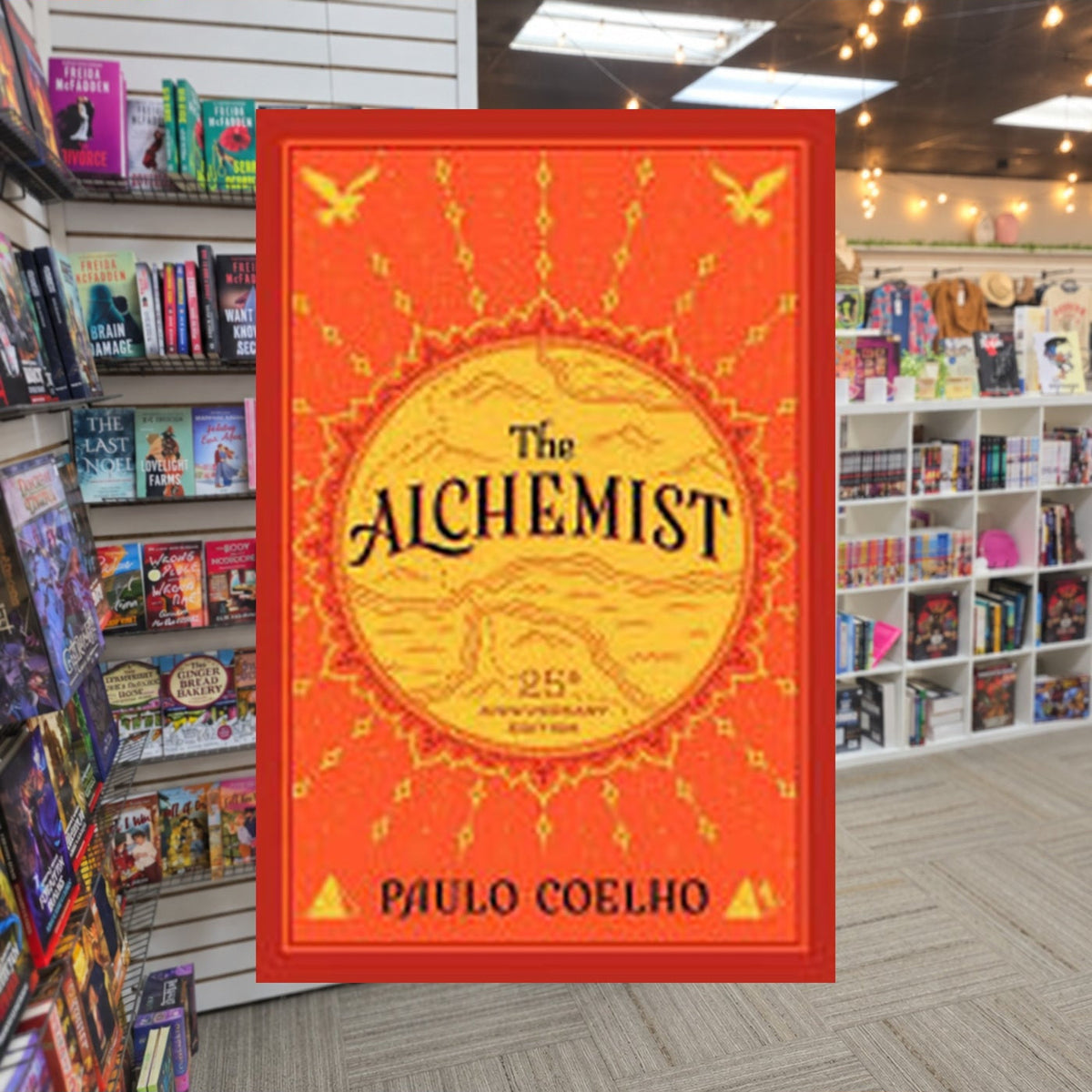 The Alchemist by Paulo Coelho — actual cover on The Perk bookstore background