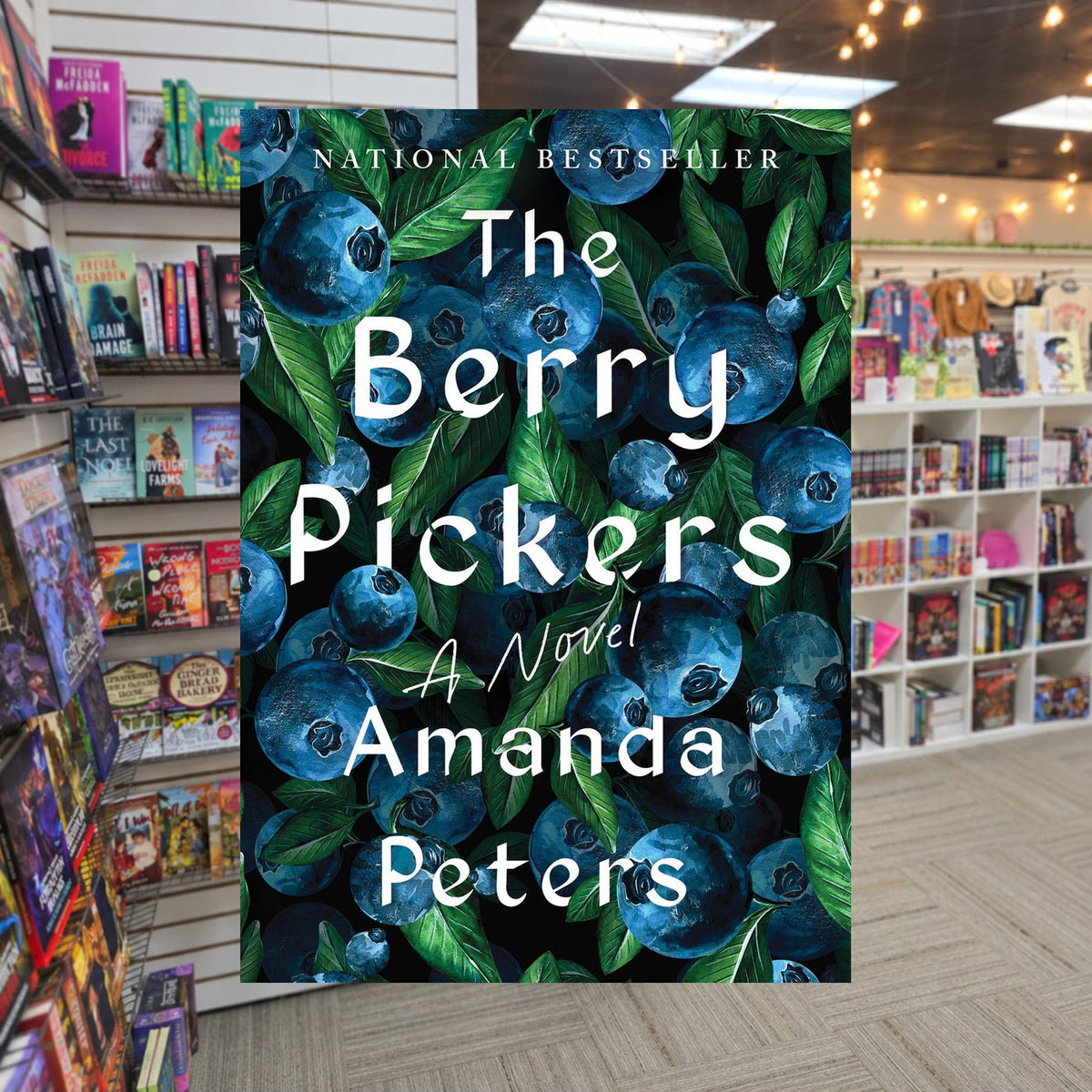 The Berry Pickers by Amanda Peters — actual cover on The Perk bookstore background