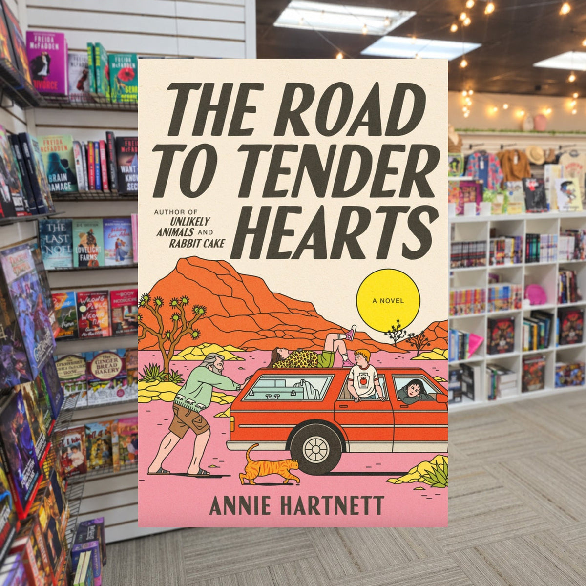 The Road to Tender Hearts by Annie Hartnett — actual cover on The Perk bookstore background