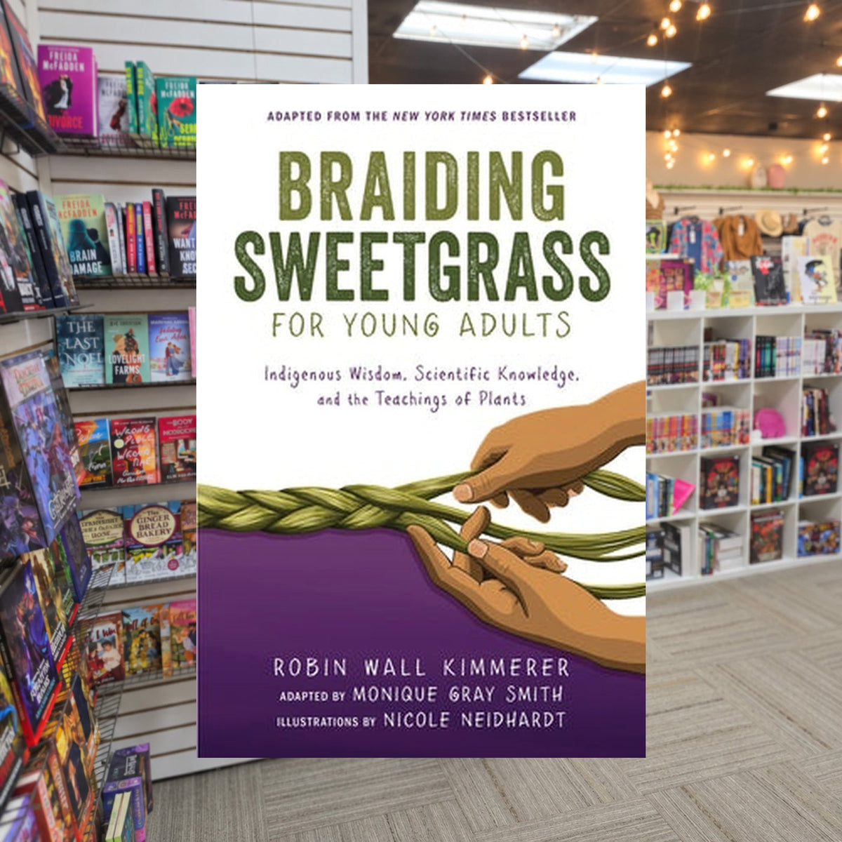 Braiding Sweetgrass for Young Adults: Indigenous Wisdom, Scientific Knowledge, and the Teachings of Plants by Robin Wall Kimmerer, Monique Gray Smith, Nicole Neidhardt (Illustrator) — actual cover on The Perk bookstore background