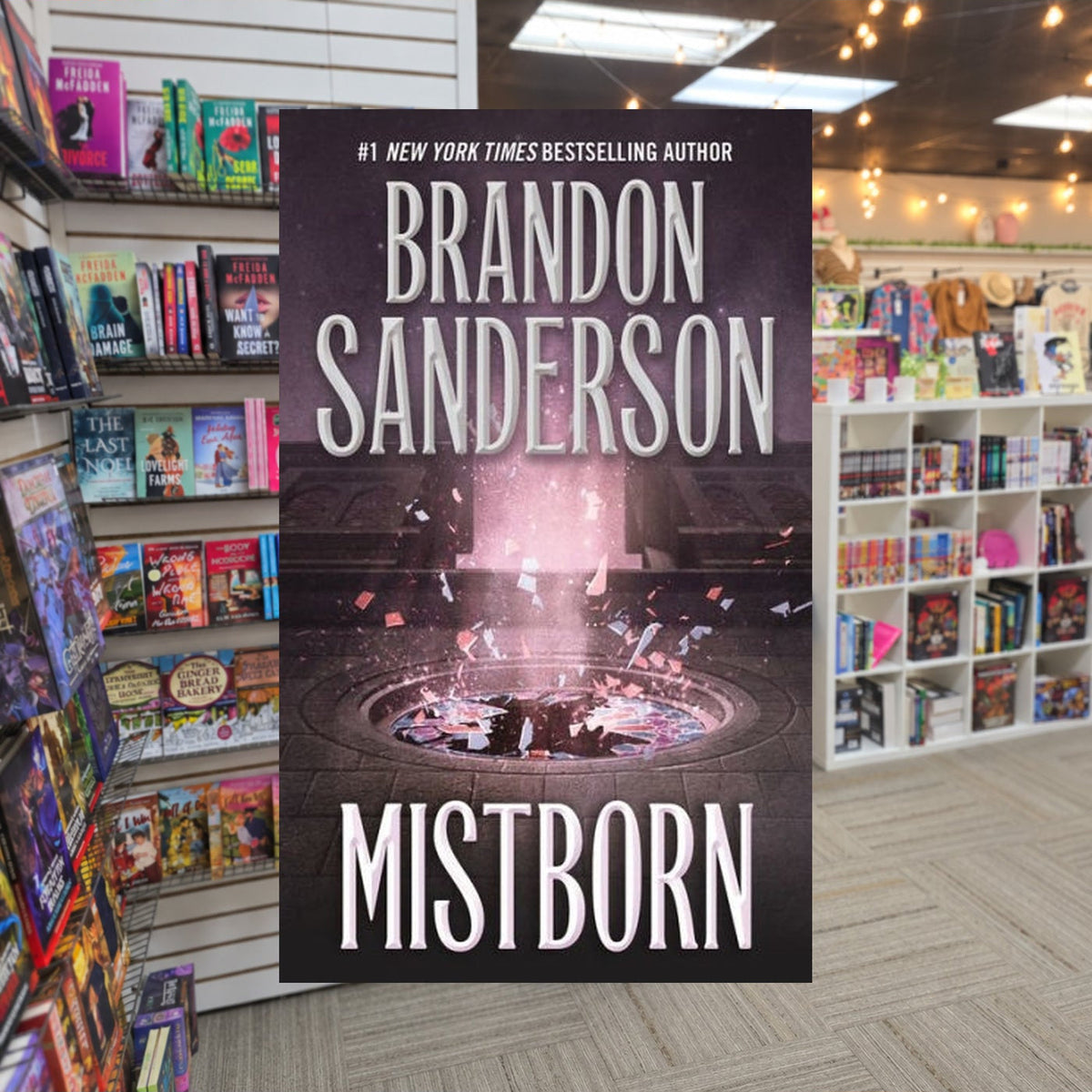 Mistborn by Brandon Sanderson — actual cover on The Perk bookstore background