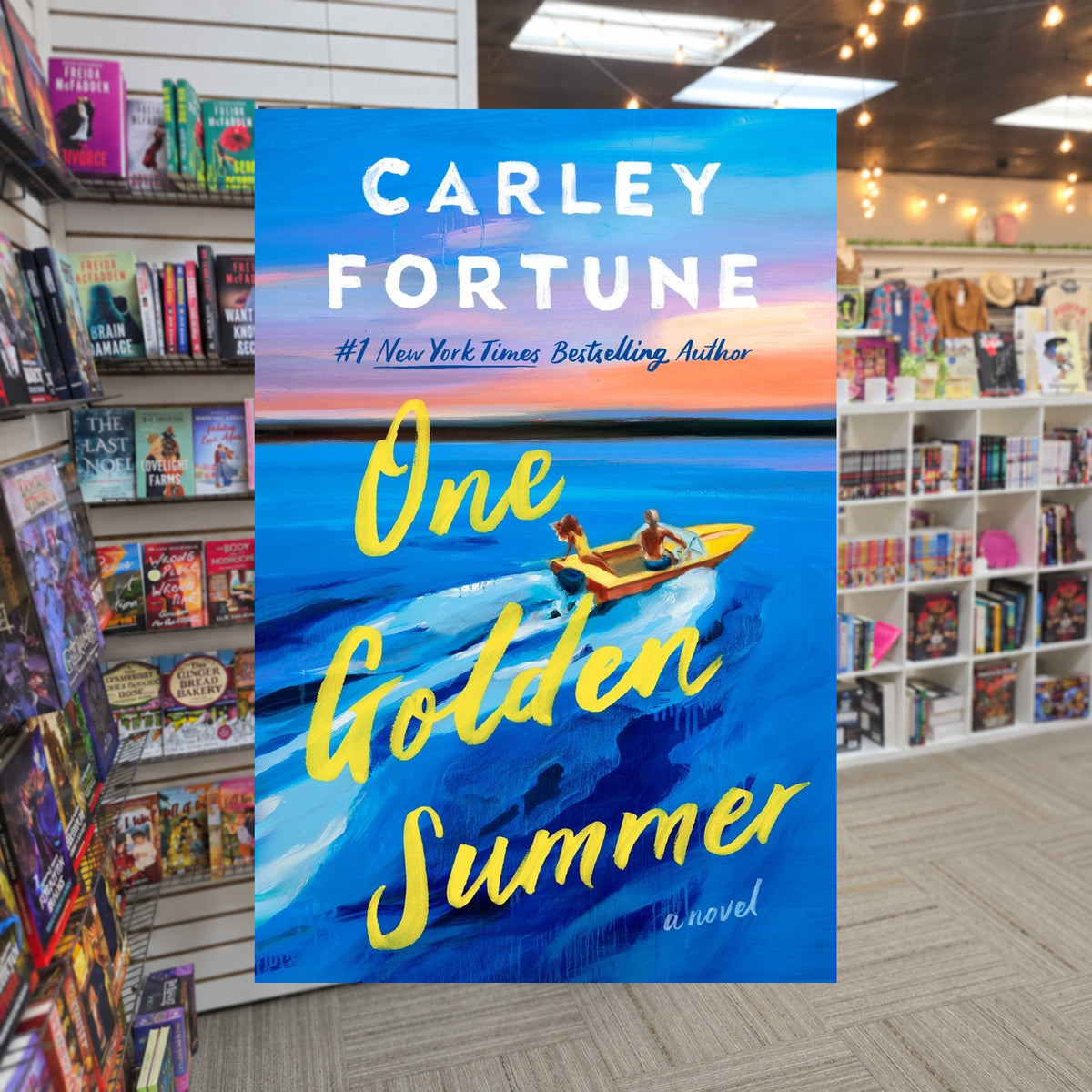 One Golden Summer by Carley Fortune — actual cover on The Perk bookstore background