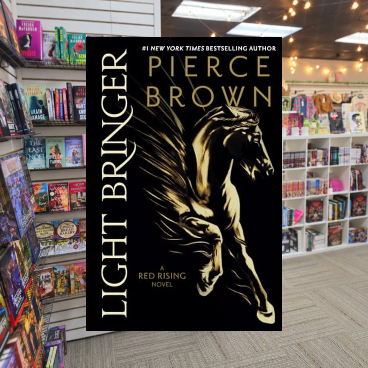 Light Bringer by Pierce Brown — actual cover on The Perk bookstore background