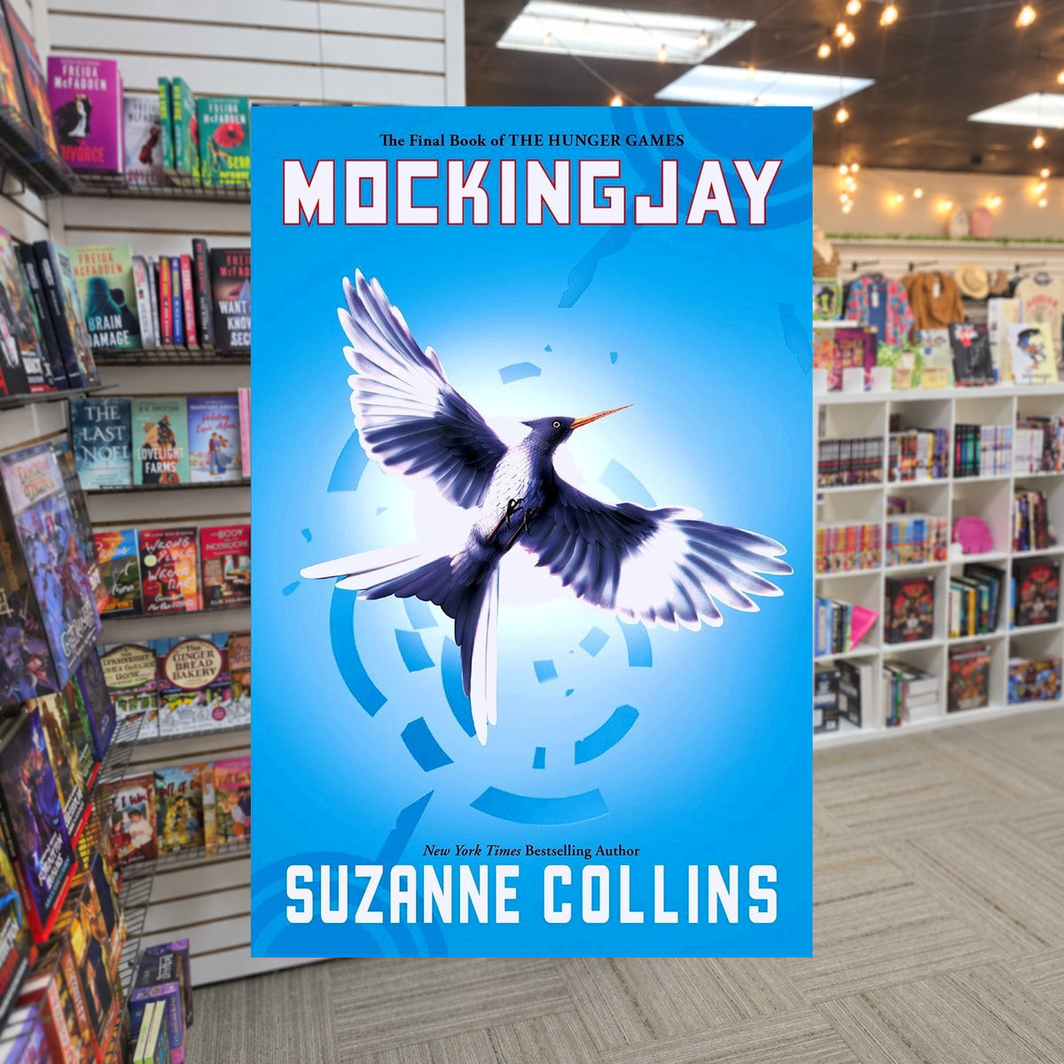 The Hunger Games #3: Mockingjay by Suzanne Collins — actual cover on The Perk bookstore background