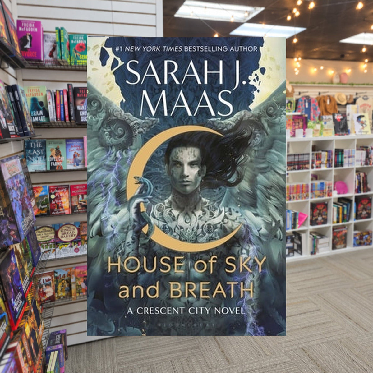 House of Sky and Breath by Sarah J. Maas — actual cover on The Perk bookstore background