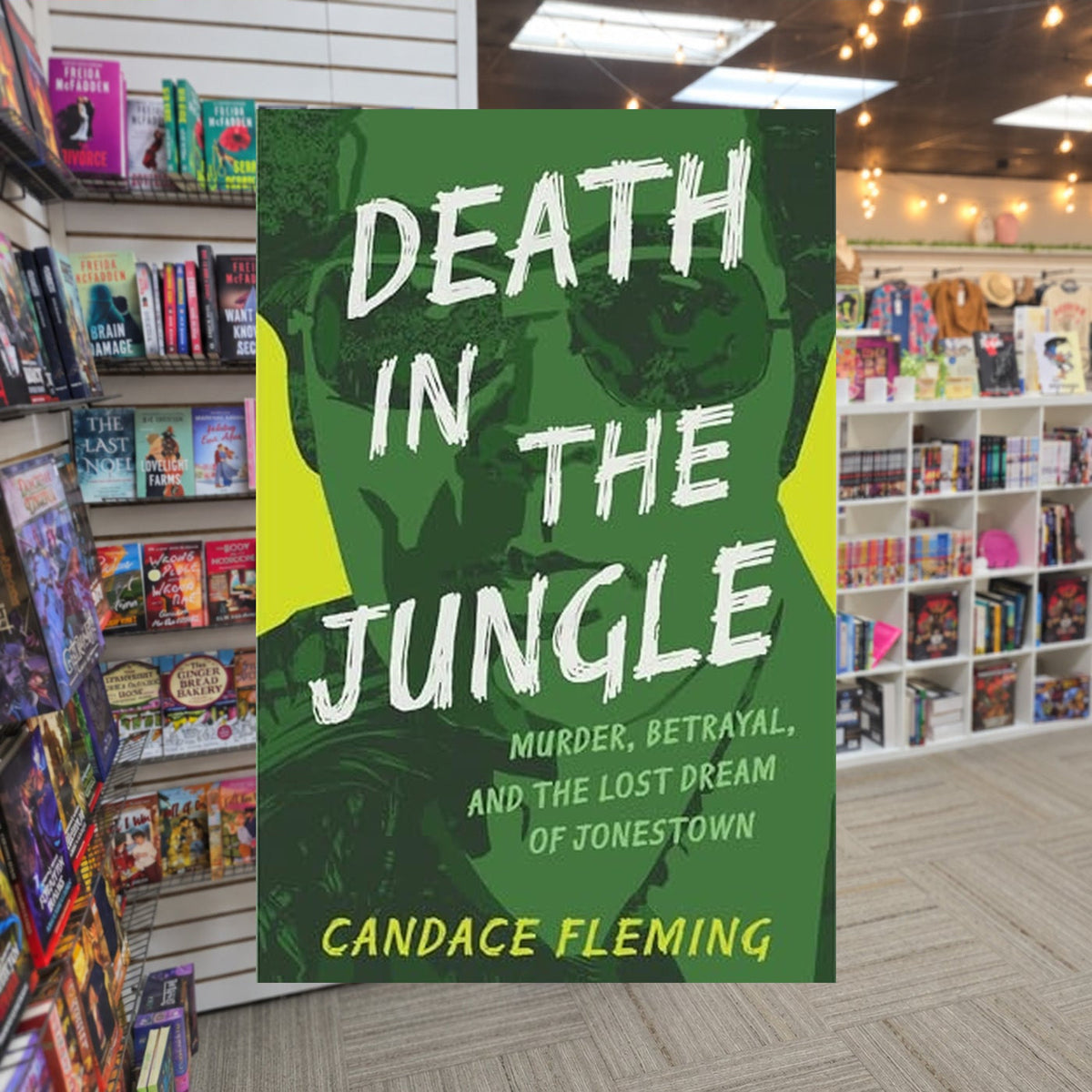 Death in the Jungle: Murder, Betrayal, and the Lost Dream of Jonestown by Candace Fleming — actual cover on The Perk bookstore background