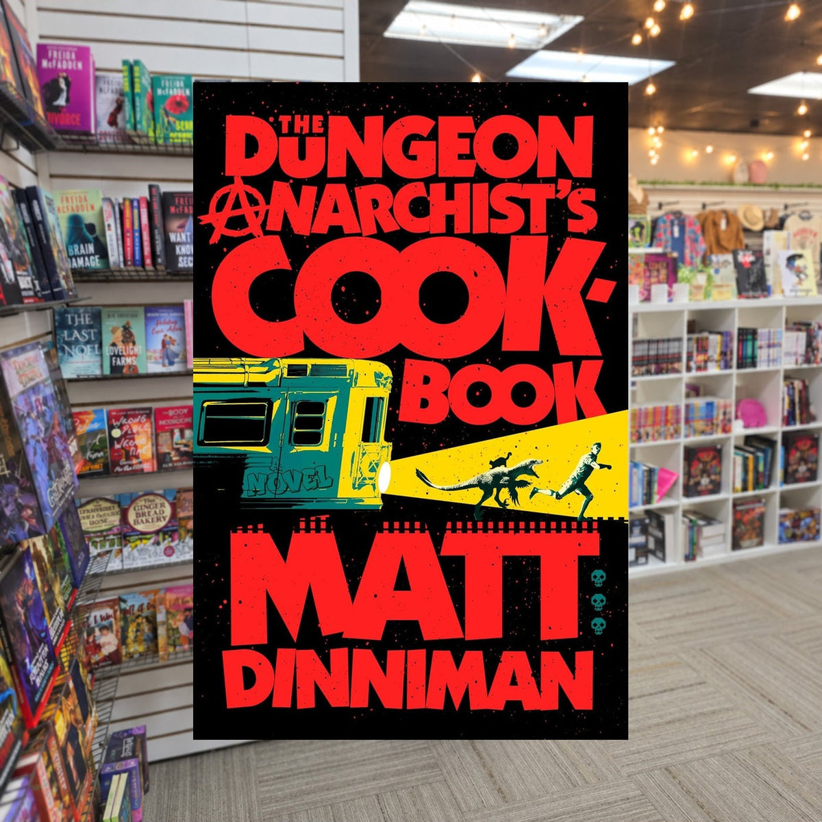 The Dungeon Anarchist's Cookbook by Matt dinniman — actual cover on The Perk bookstore background