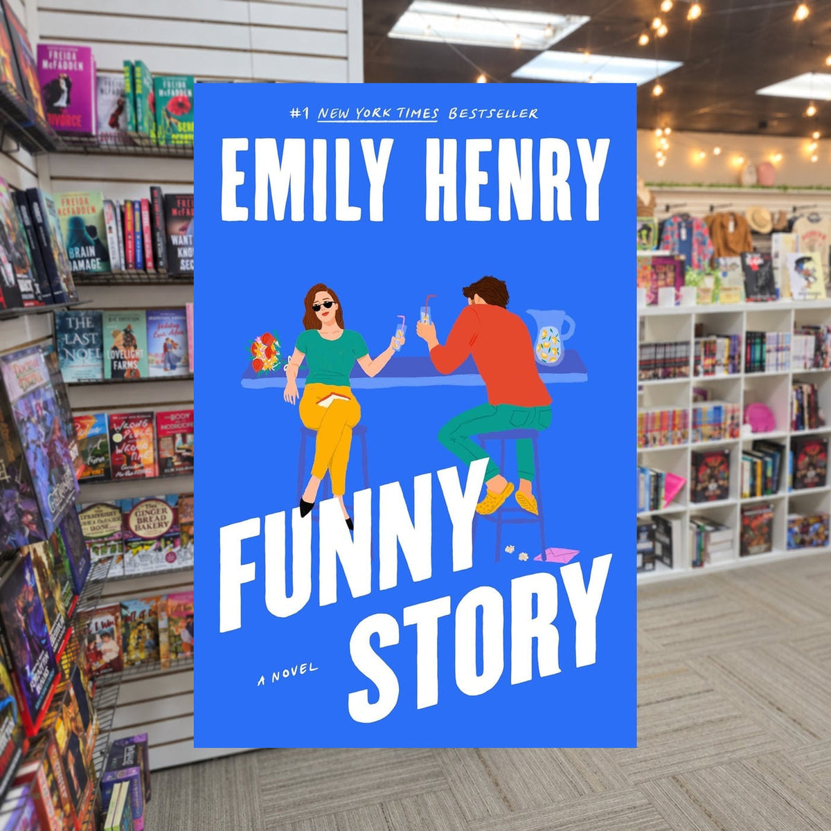 Funny Story by Emily Henry — actual cover on The Perk bookstore background