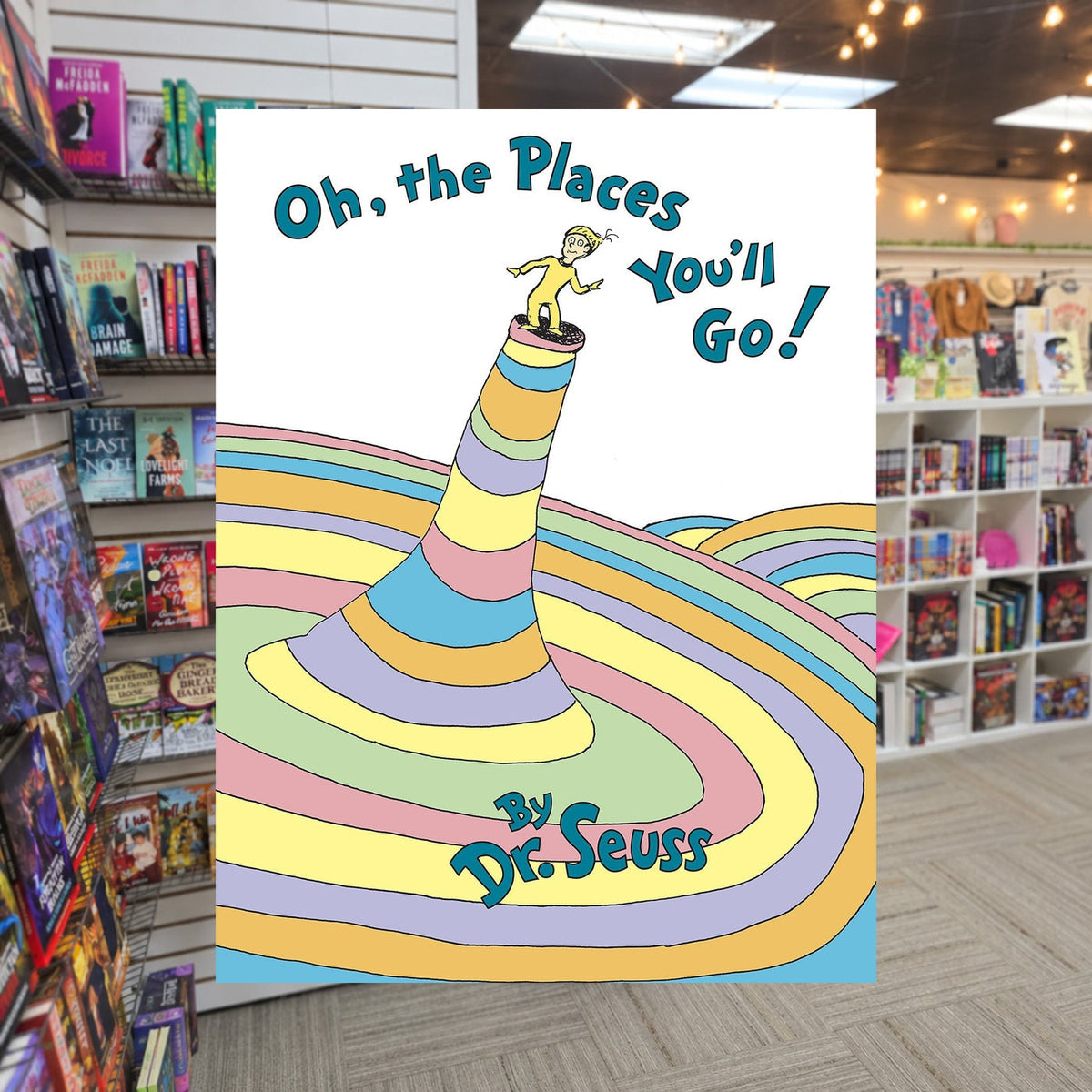 Oh, the Places You’ll Go! by Dr. Seuss — actual cover on The Perk bookstore background