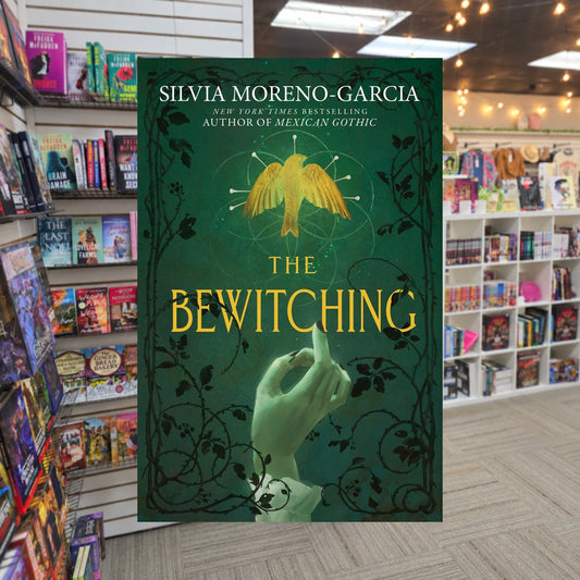 The Bewitching by Silvia Moreno-Garcia — actual cover on The Perk bookstore background