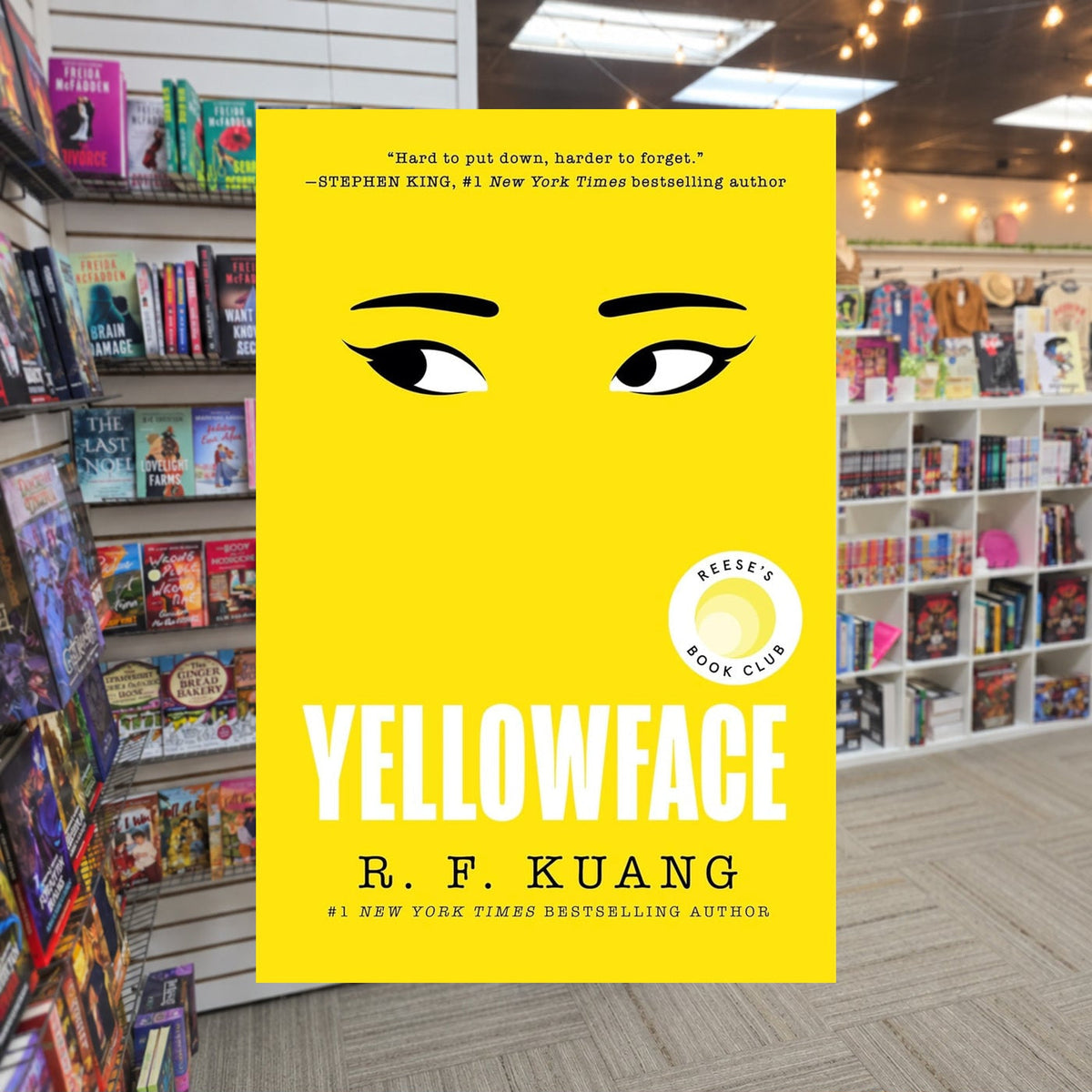 Yellowface by R.F. Kuang — actual cover on The Perk bookstore background