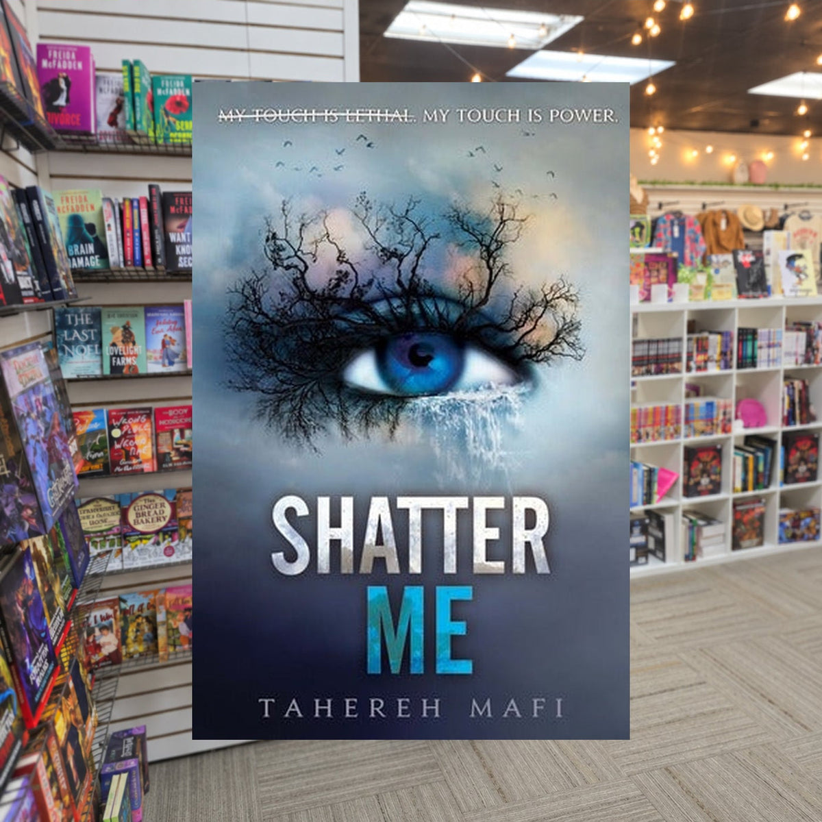 Shatter Me #1: Shatter Me by Tahereh Mafi — actual cover on The Perk bookstore background