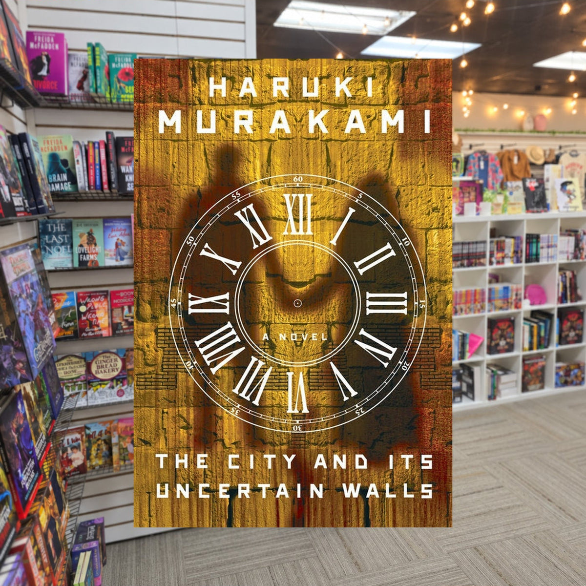 The City and Its Uncertain Walls — actual cover on The Perk bookstore background