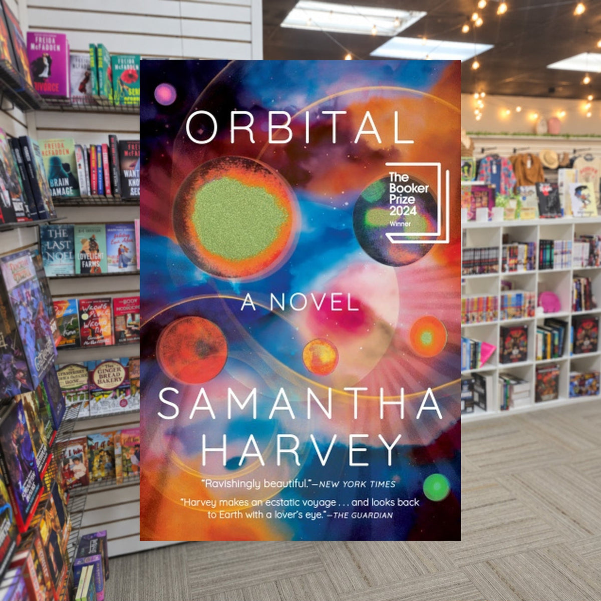 Orbital by Samantha Harvey — actual cover on The Perk bookstore background