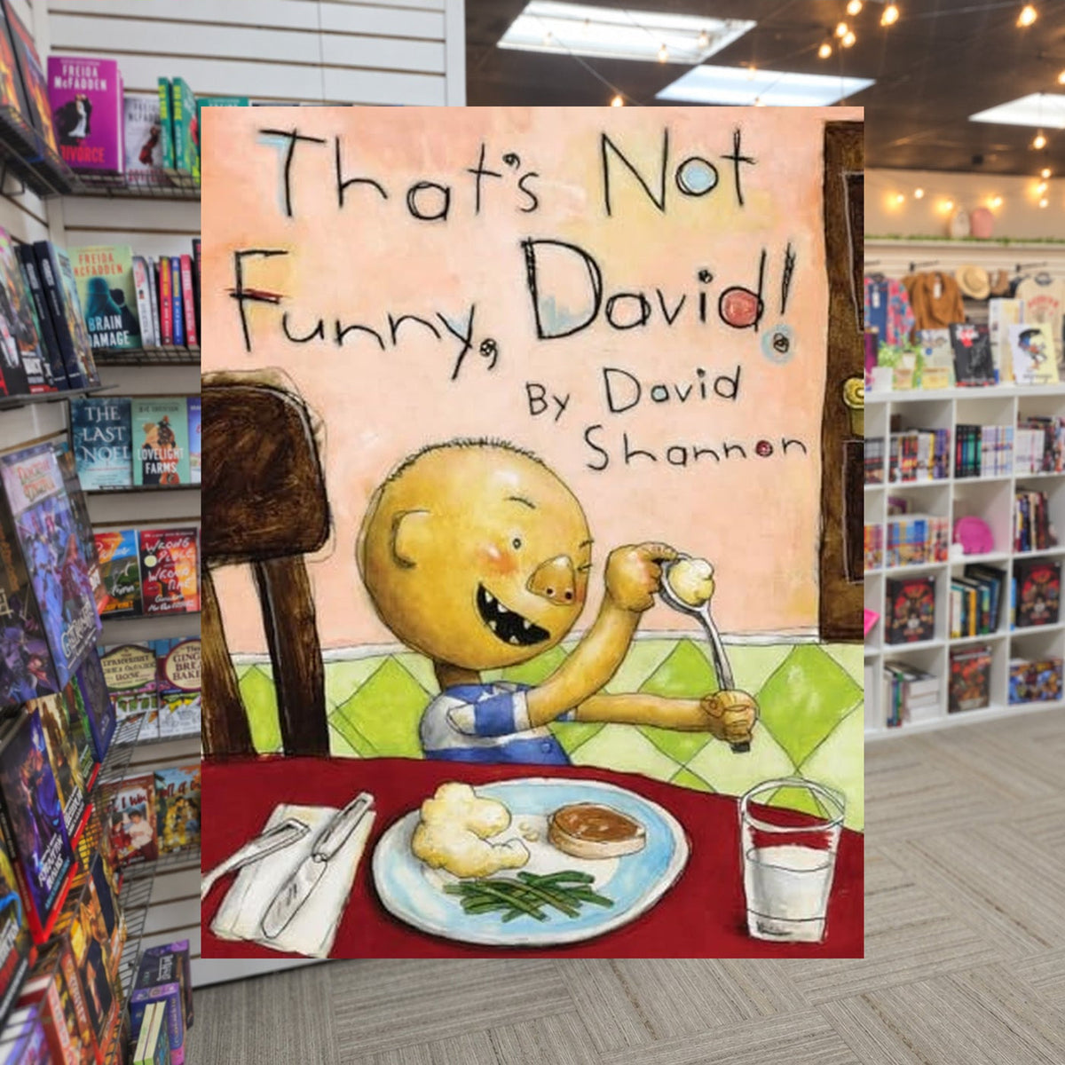 That's Not Funny, David! by David Shannon — actual cover on The Perk bookstore background