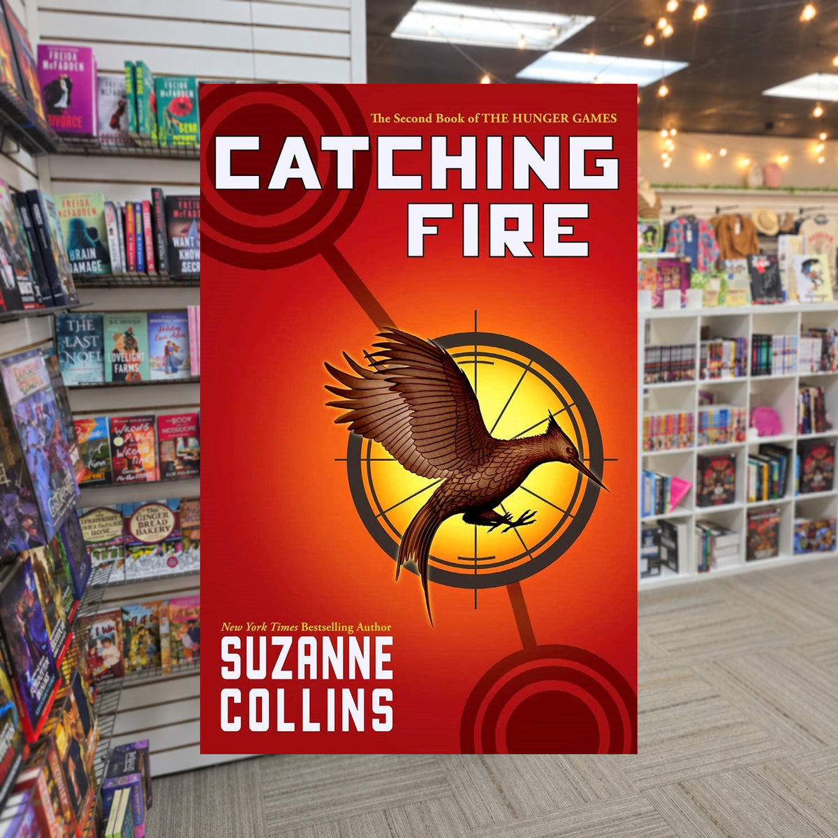 The Hunger Games #2: Catching Fire by Suzanne Collins — actual cover on The Perk bookstore background