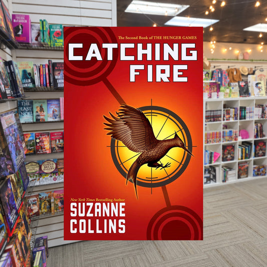 The Hunger Games #2: Catching Fire by Suzanne Collins — actual cover on The Perk bookstore background