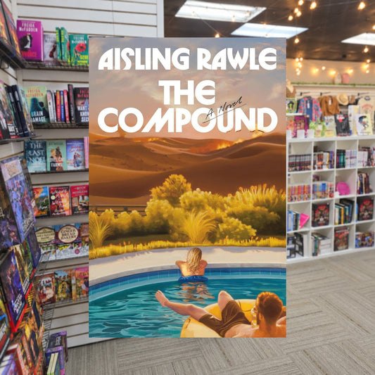 The Compound by Aisling Rawle — actual cover on The Perk bookstore background