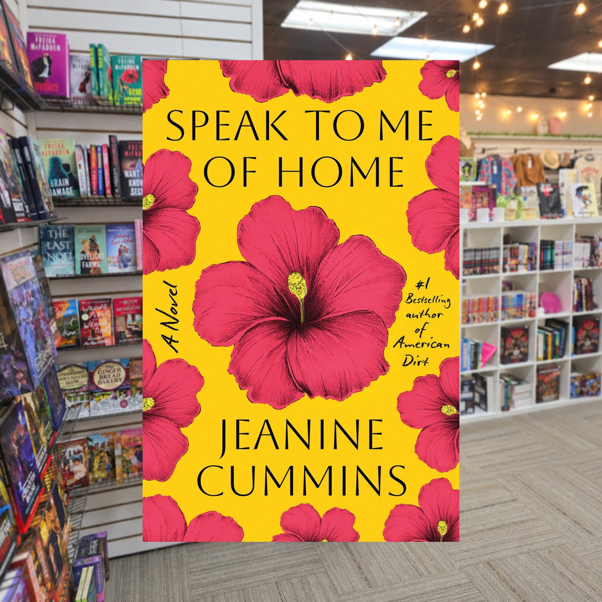 Speak to Me of Home by Jeanine Cummins — actual cover on The Perk bookstore background