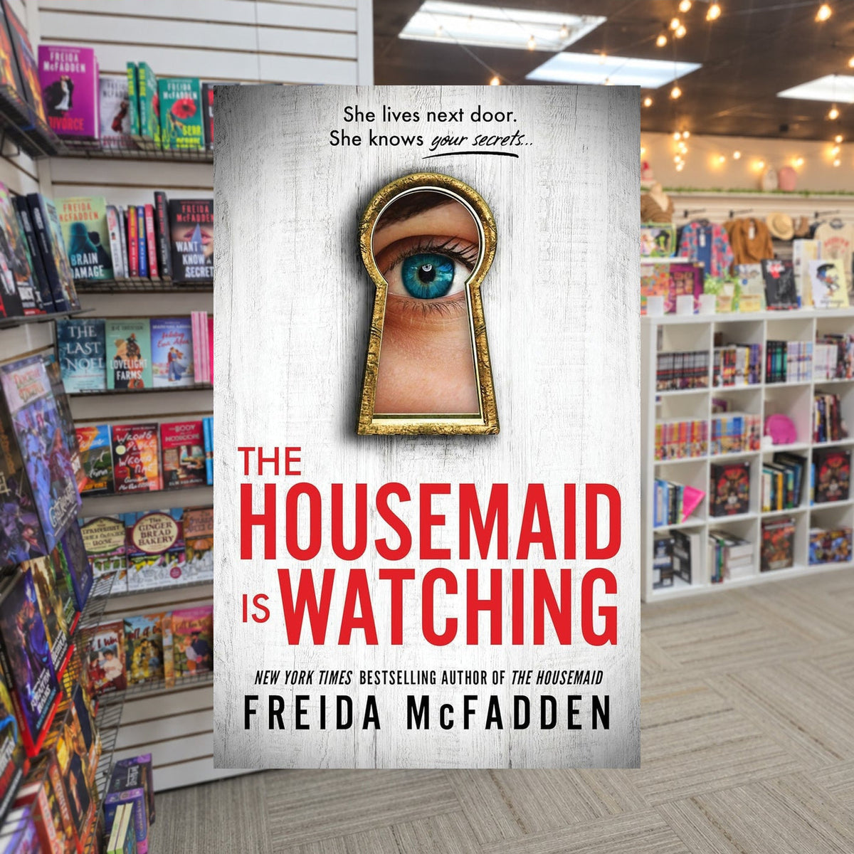 The Housemaid Is Watching by Freida McFadden — actual cover on The Perk bookstore background
