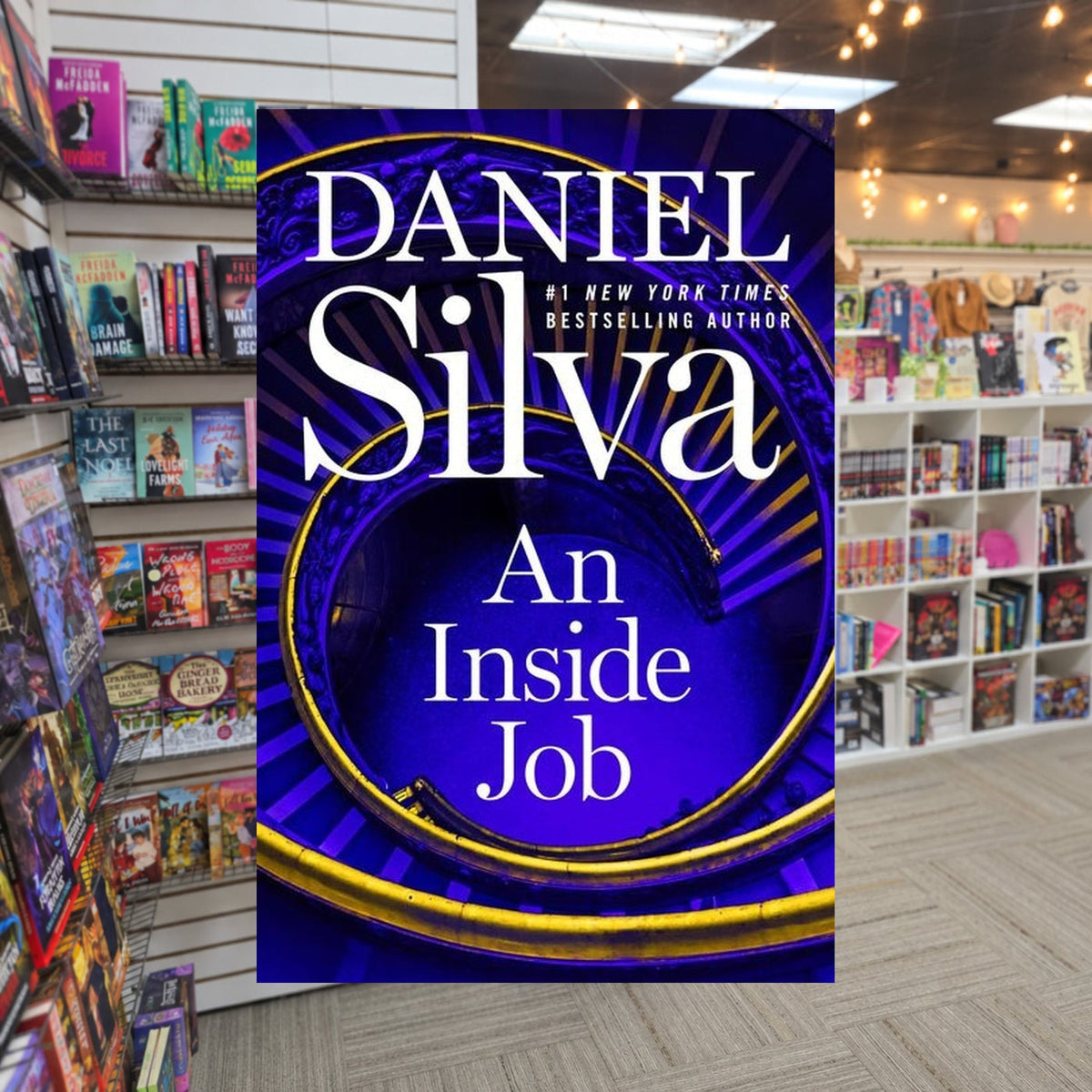 An Inside Job by Daniel Silva — actual cover on The Perk bookstore background